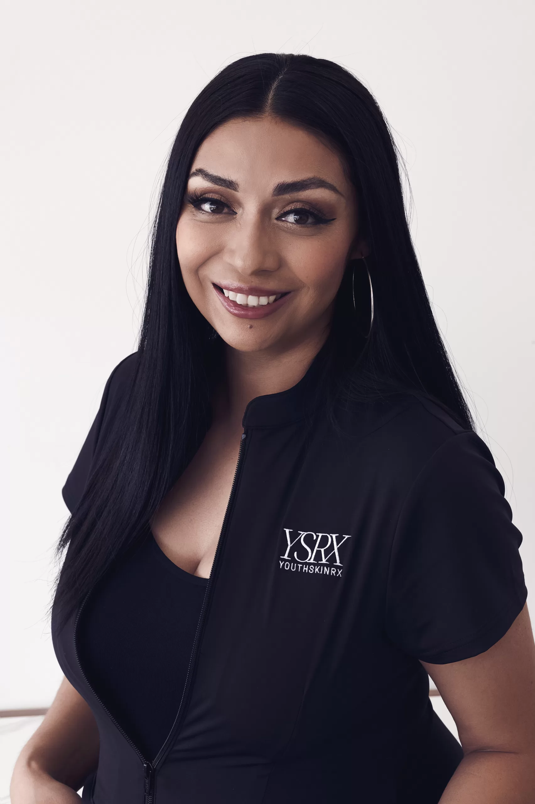 Woman wearing a black dress, representing the staff of Youth Skin Rx.