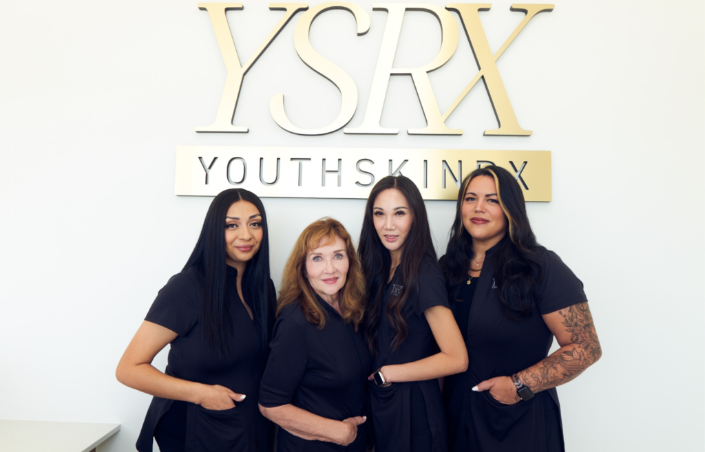 Youth Skin Rx Staff Image IN front of office Sign, exemplifying professionalism and expertise in skincare services.